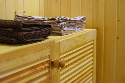 Close-up of stack on wooden wall at home