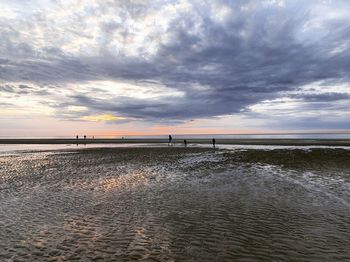 Scenic view of beach against sky during sunset