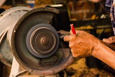 Midsection of man working on machine