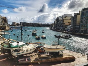 Sailboats moored in harbor