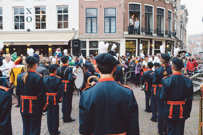 Rear view of people walking in city