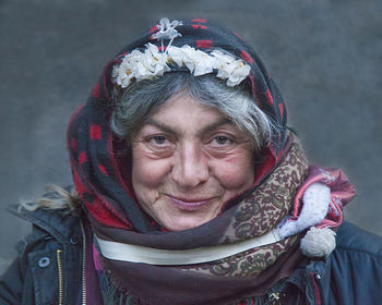 Close-up portrait of smiling woman in snow