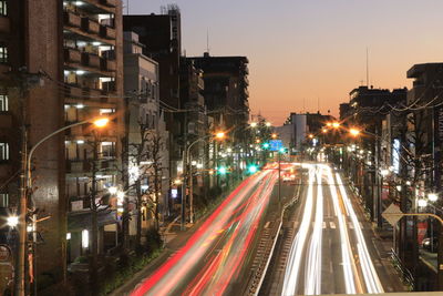 Light trails on road in city at night