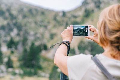 Man photographing camera on mobile phone