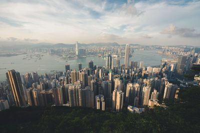 Panoramic view of buildings against cloudy sky