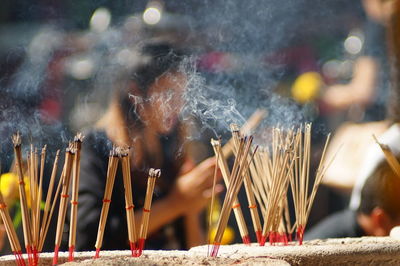 Close-up of lit candles in temple