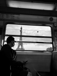 Rear view of man sitting in train