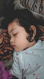 High angle view of cute baby sleeping on bed