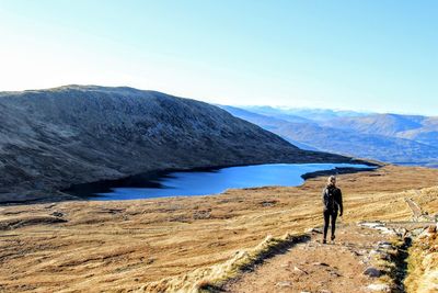 Rear view of man walking on mountain