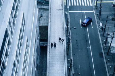 High angle view of people walking on road
