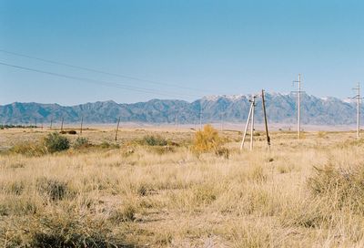 Scenic view of field against clear sky with mountains