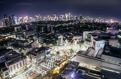 High angle view of illuminated cityscape against sky at night