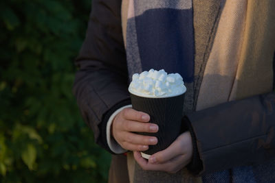 Midsection of person holding ice cream