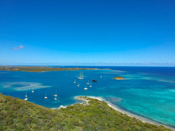 High angle view of sea against blue sky