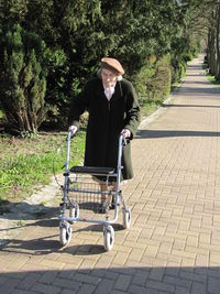 Man cycling on footpath amidst trees