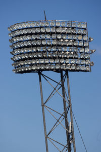 Low angle view of floodlight against blue sky