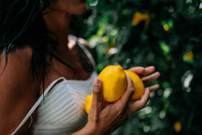 Close-up of woman holding fruit