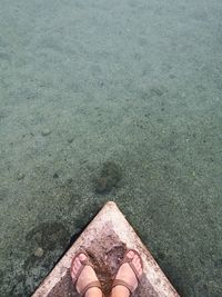 Low section of woman standing on beach