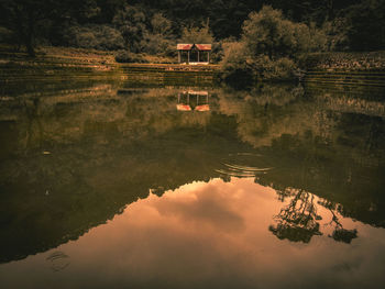 Scenic view of lake by building against sky