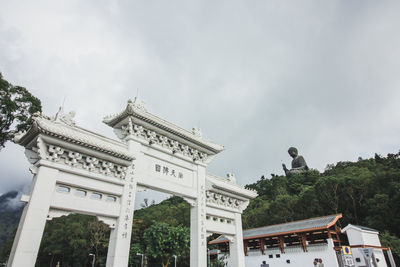 Low angle view of building against cloudy sky