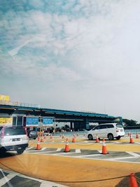 Cars on street against sky