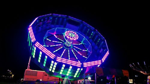 Low angle view of illuminated ferris wheel