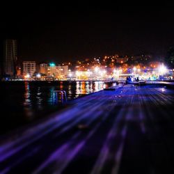 Illuminated city street at night