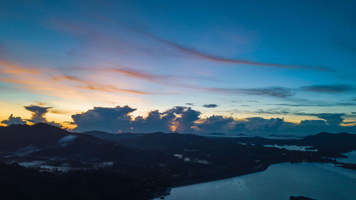 Scenic view of silhouette mountains against sky during sunset