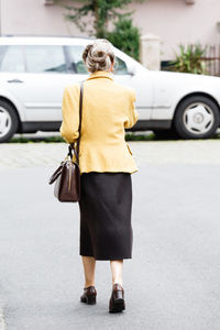 Woman standing on city street