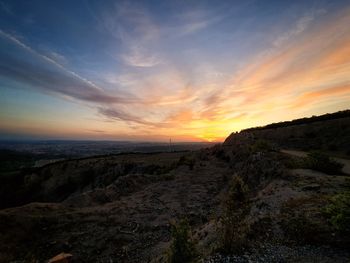 Scenic view of field against sky during sunset