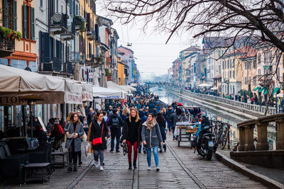 People walking on street in city during rainy season