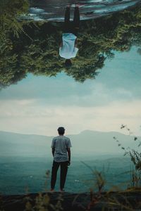 Rear view of man standing on shore