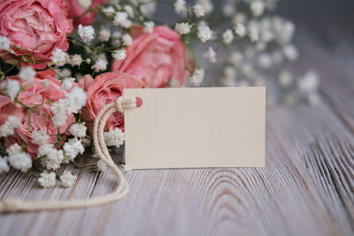 Bouquet of flowers and blank white card for text. mockup tag. postcard