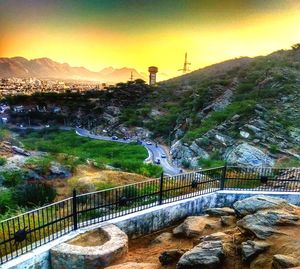 Bridge over landscape against sky during sunset