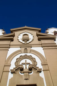 Low angle view of building against clear blue sky