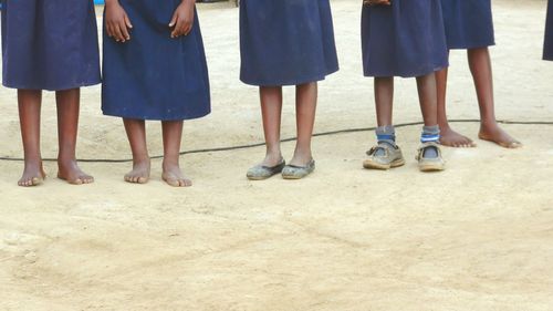 Low section of people standing on footpath