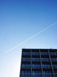 Vapor trail against clear blue sky