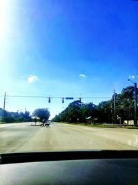 Road against clear sky seen through car windshield