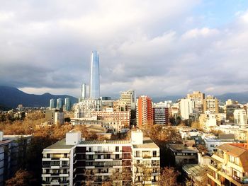 City skyline against cloudy sky