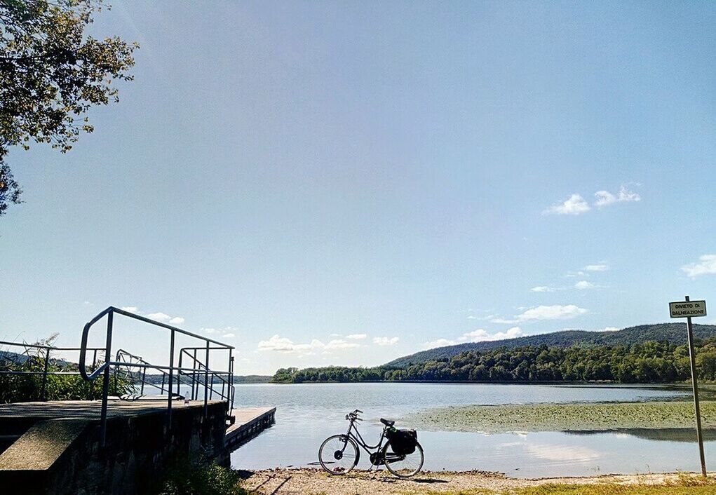 BICYCLES BY RAILING AGAINST SKY