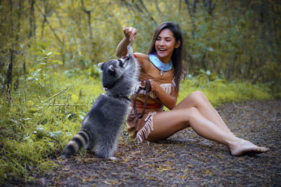 Young woman with dog sitting in park