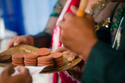 Cropped hand of man and woman running wedding ritual 