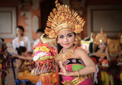 Portrait of young woman in costume dancing during celebration