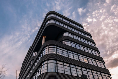 Low angle view of building against cloudy sky