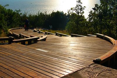 Surface level of boardwalk in park in front of sunny day