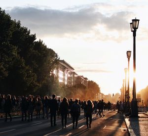 People on street against sky in city