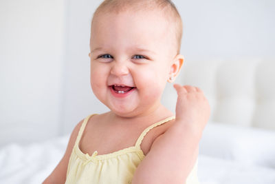Portrait of cute baby girl smiling with first milk teeth. healthy newborn child