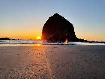 Scenic view of sea against clear sky during sunset