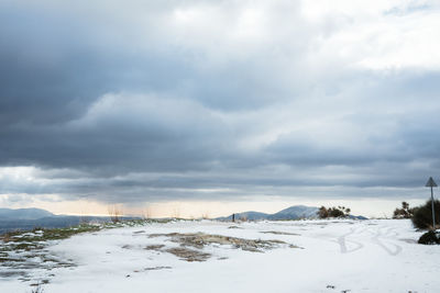 Snow covered landscape against sky