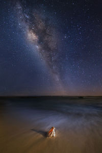 Scenic view of sea against sky at night